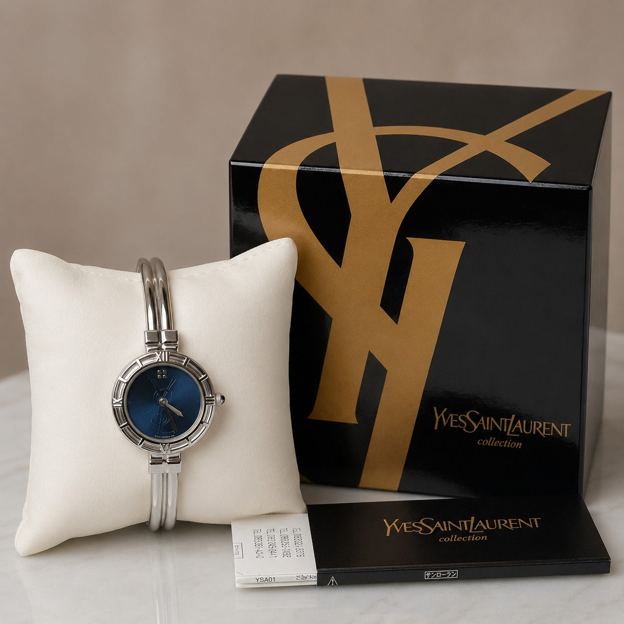 Yves Saint Laurent bangle z niebieską tarczą